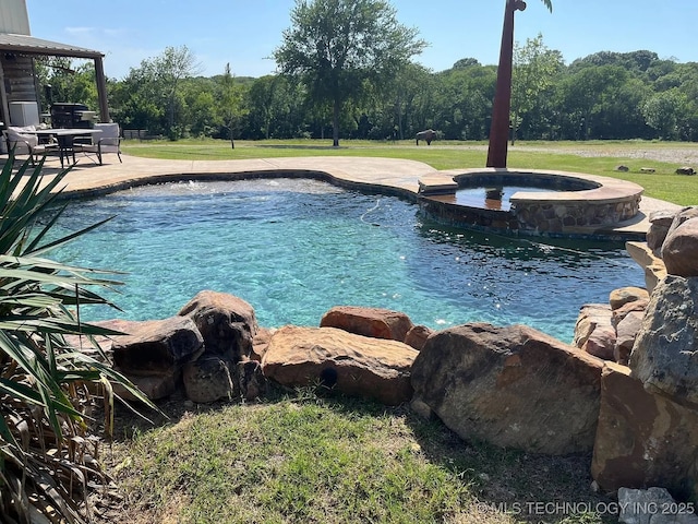 17 Zachary Taylor, Durant, OK 74701 - view of swimming pool featuring a pool with connected hot tub, a patio, and a lawn