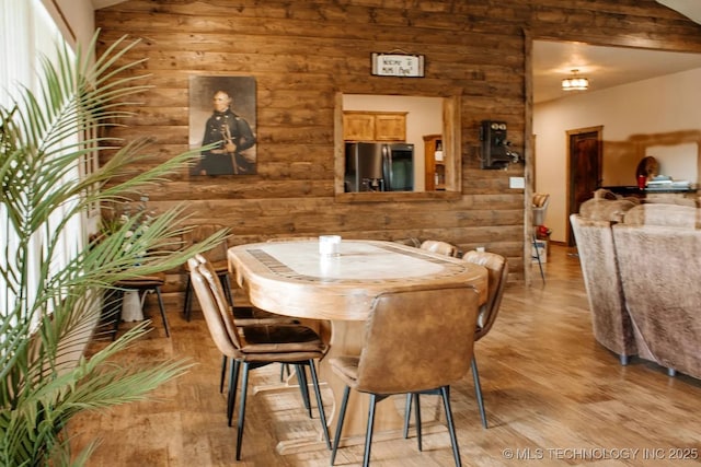 17 Zachary Taylor, Durant, OK 74701 - dining room featuring light wood-type flooring, wood walls, and lofted ceiling