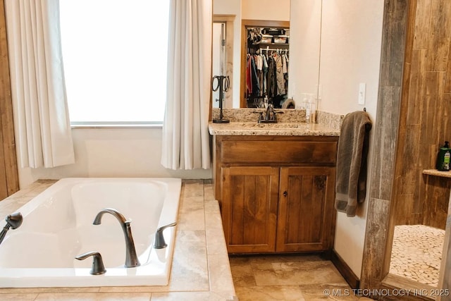 17 Zachary Taylor, Durant, OK 74701 - bathroom featuring a garden tub, vanity, and a spacious closet