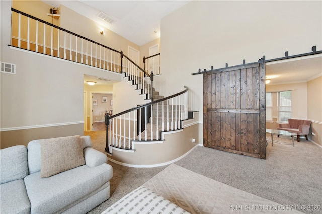 9306 S 94th E Ave, Tulsa, OK 74133 - stairway featuring carpet, baseboards, a high ceiling, and a barn door