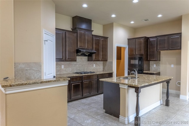 1425 Switchgrass, Edmond, OK 73013 - kitchen featuring black appliances, under cabinet range hood, a sink, light stone counters, and light tile patterned floors