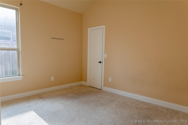 1425 Switchgrass, Edmond, OK 73013 - empty room with carpet floors, baseboards, and vaulted ceiling
