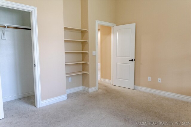 1425 Switchgrass, Edmond, OK 73013 - unfurnished bedroom with carpet, a closet, and baseboards