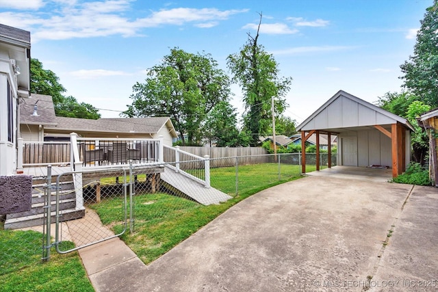 1856 E 17th St, Tulsa, OK 74104 - view of yard with concrete driveway, a carport, and a wooden deck