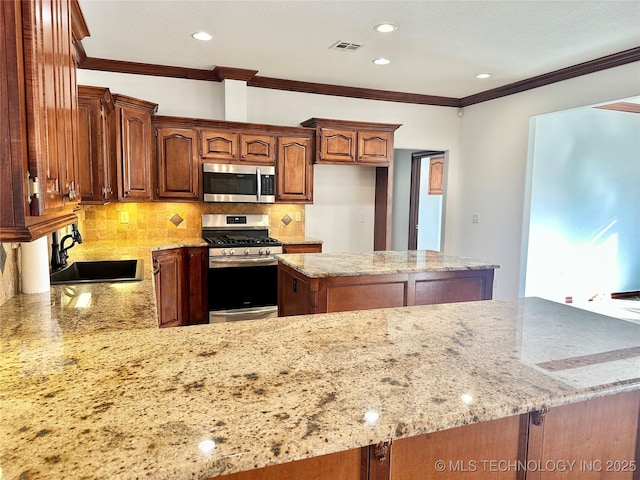 2013 State Highway 9a, Eufaula, OK 74432 - kitchen featuring stainless steel appliances, a sink, light stone counters, backsplash, and crown molding