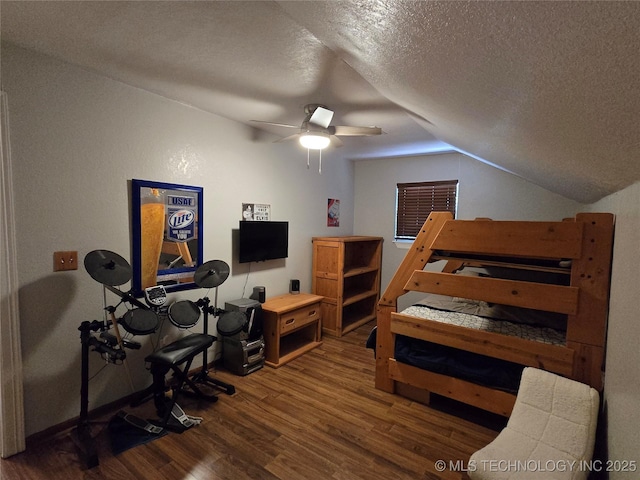 110534 S 4183rd Rd, Checotah, OK 74426 - bedroom with wood finished floors, lofted ceiling, a textured ceiling, and ceiling fan
