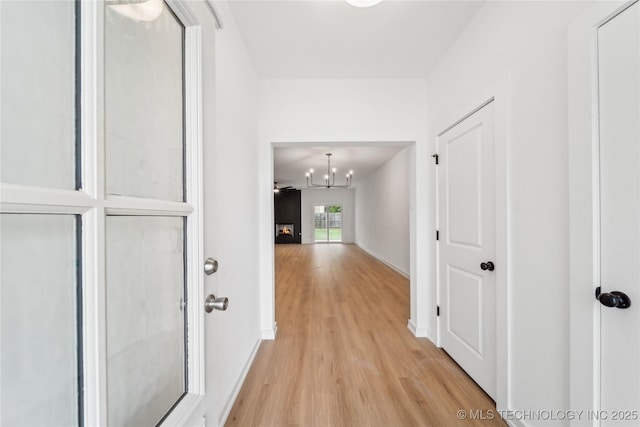 2504 W Birmingham St, Broken Arrow, OK 74011 - hall with light wood-style flooring, a chandelier, and baseboards