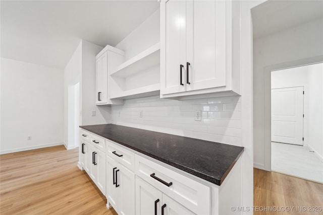 2504 W Birmingham St, Broken Arrow, OK 74011 - kitchen with open shelves, light wood-style flooring, decorative backsplash, white cabinets, and baseboards