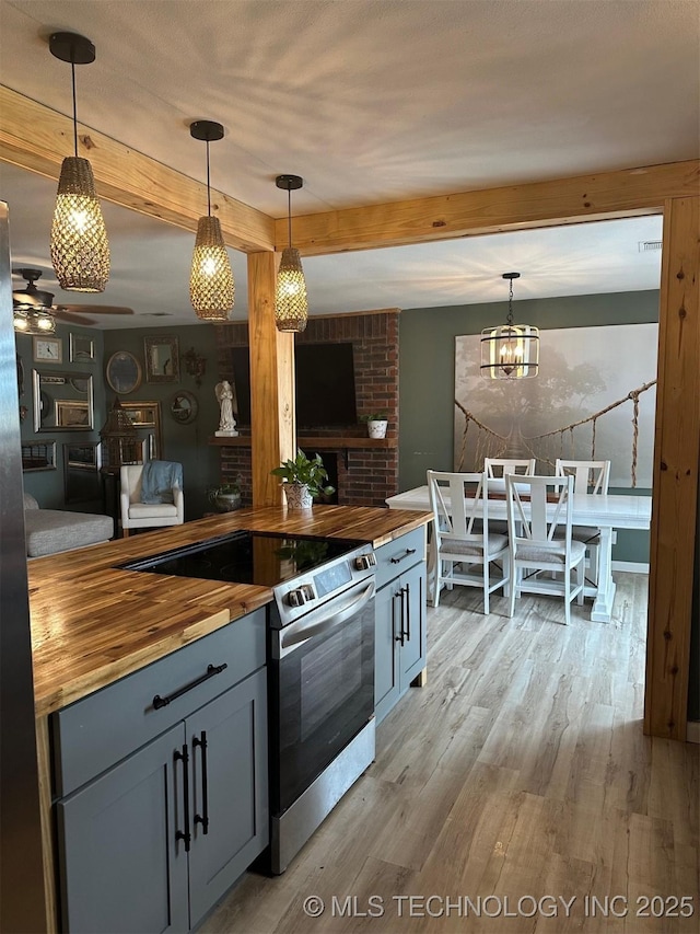 166 N Spruce Ave, Bartlesville, OK 74006 - kitchen featuring wooden counters, electric stove, beam ceiling, and light wood finished floors