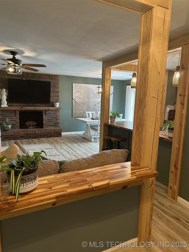 166 N Spruce Ave, Bartlesville, OK 74006 - living room featuring wood finished floors, a ceiling fan, and baseboards