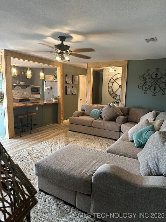 166 N Spruce Ave, Bartlesville, OK 74006 - living room with wood finished floors and ceiling fan