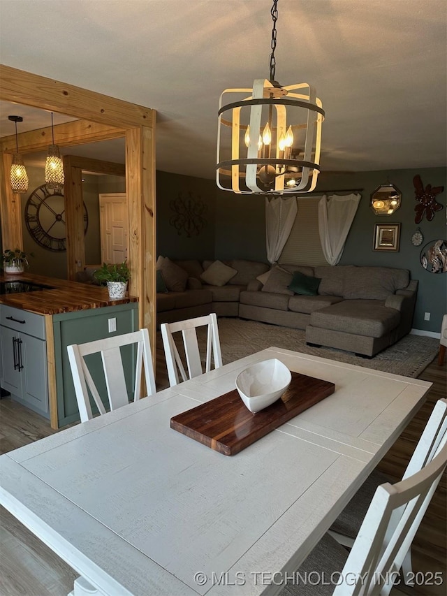 166 N Spruce Ave, Bartlesville, OK 74006 - dining area with wood finished floors, a chandelier, and baseboards
