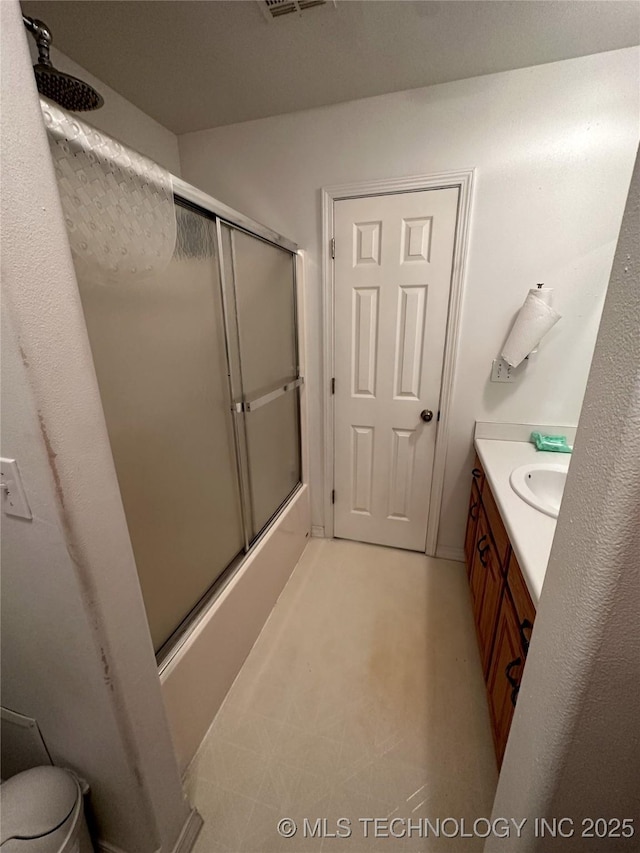 108 NW Division St, Red Oak, OK 74563 - full bathroom with vanity, shower / bath combination with glass door, and toilet