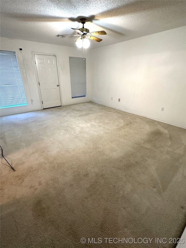 108 NW Division St, Red Oak, OK 74563 - empty room with light carpet, a ceiling fan, a textured ceiling, and baseboards