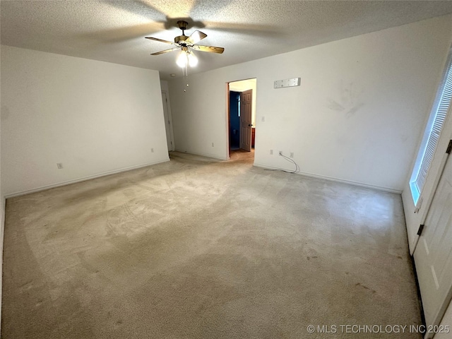 108 NW Division St, Red Oak, OK 74563 - spare room featuring a ceiling fan, light colored carpet, a textured ceiling, and baseboards