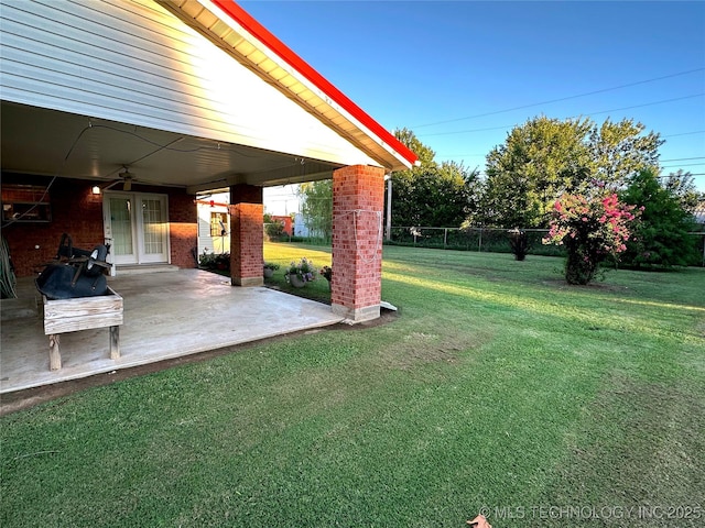 108 NW Division St, Red Oak, OK 74563 - view of grassy yard with a ceiling fan, a patio area, and french doors