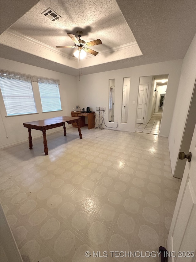 108 NW Division St, Red Oak, OK 74563 - game room featuring a tray ceiling, ceiling fan, light flooring, a textured ceiling, and baseboards