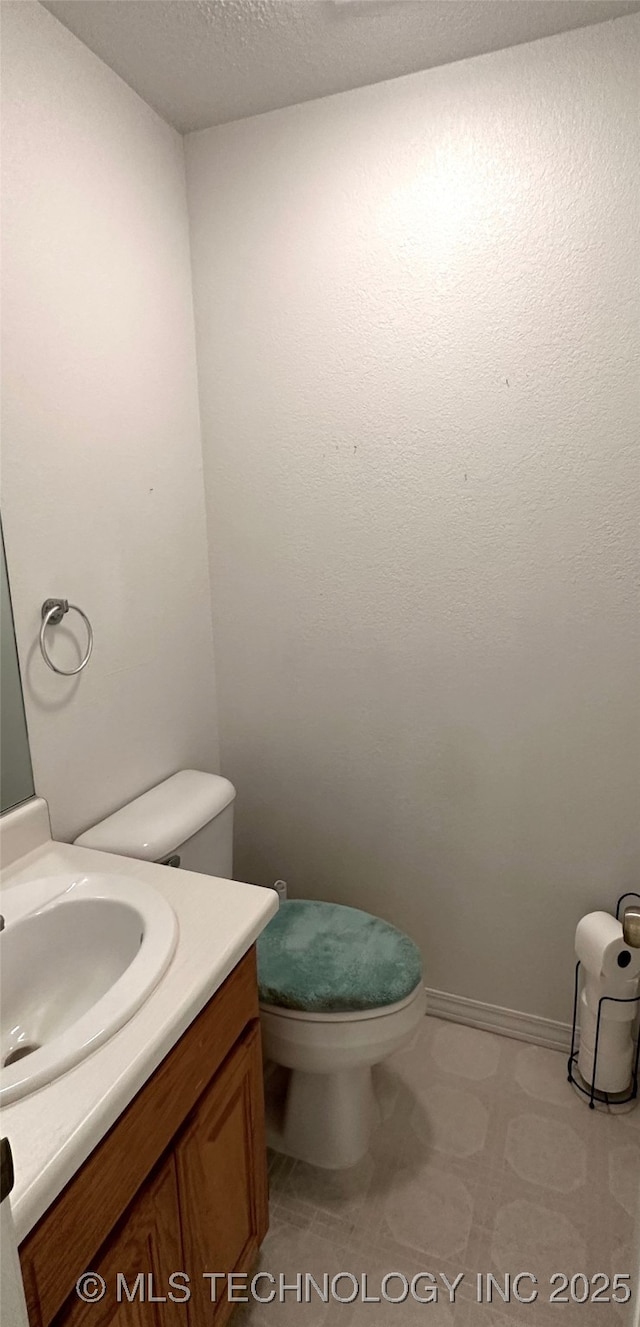 108 NW Division St, Red Oak, OK 74563 - half bath with toilet, vanity, and tile patterned floors