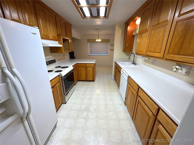 108 NW Division St, Red Oak, OK 74563 - kitchen with white appliances, a sink, under cabinet range hood, light floors, and brown cabinets