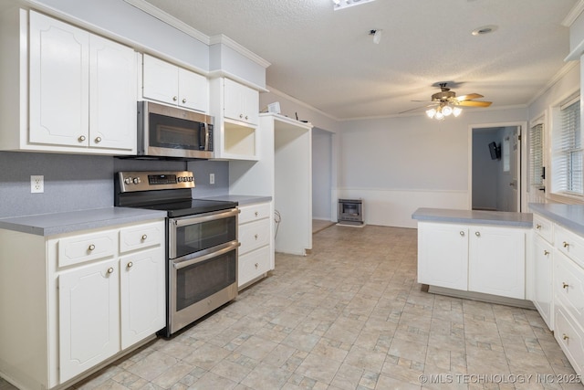 901 Christy, Calera, OK 74730 - kitchen featuring stainless steel appliances, crown molding, ceiling fan, white cabinets, and a peninsula