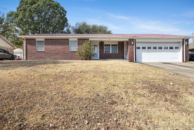901 Christy, Calera, OK 74730 - single story home with brick siding, a garage, driveway, and a front yard