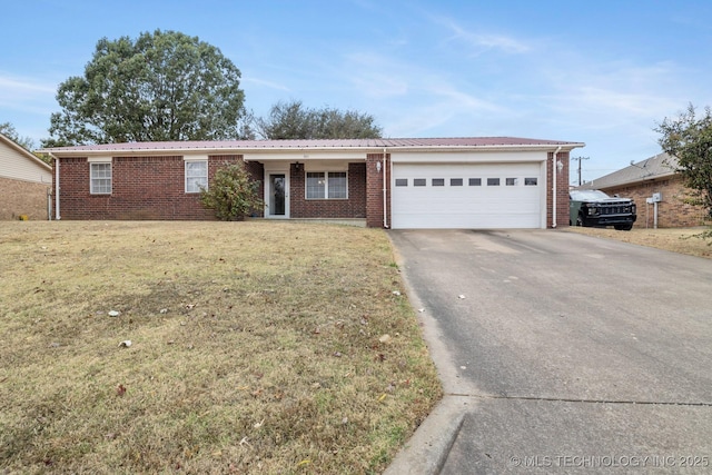 901 Christy, Calera, OK 74730 - ranch-style house featuring an attached garage, concrete driveway, a front lawn, and brick siding