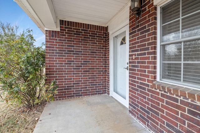 901 Christy, Calera, OK 74730 - doorway to property featuring brick siding and covered porch