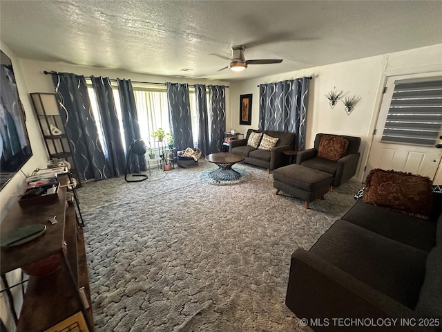 661 12th NW, Ardmore, OK 73401 - carpeted living room featuring ceiling fan and a textured ceiling