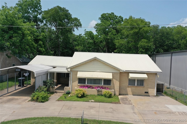 661 12th NW, Ardmore, OK 73401 - ranch-style home with brick siding, concrete driveway, and metal roof