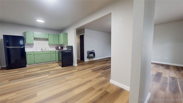 420 W State, Stratford, OK 74872 - kitchen with black appliances, green cabinetry, a sink, light wood-style flooring, and baseboards