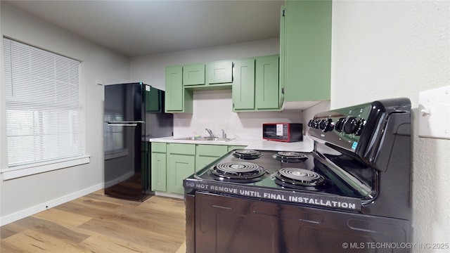 420 W State, Stratford, OK 74872 - kitchen with green cabinets, freestanding refrigerator, electric stove, a sink, and light countertops
