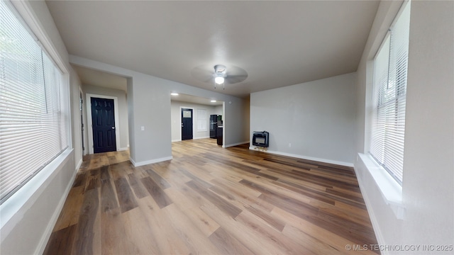 420 W State, Stratford, OK 74872 - unfurnished living room with heating unit, plenty of natural light, wood finished floors, and baseboards
