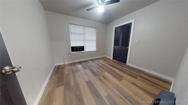 420 W State, Stratford, OK 74872 - unfurnished room featuring wood finished floors, ceiling fan, baseboards, and cooling unit