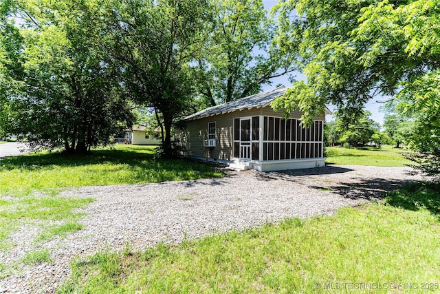 609 E Tejon Ave, Bristow, OK 74010 - view of green lawn featuring a sunroom