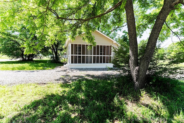 609 E Tejon Ave, Bristow, OK 74010 - view of side of home featuring a sunroom