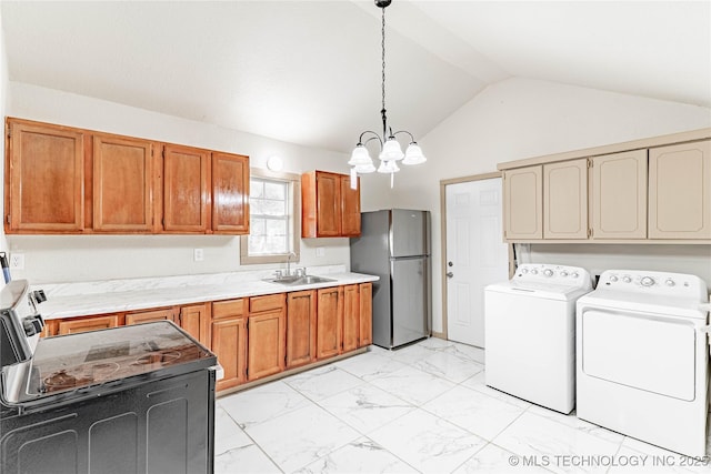 609 E Tejon Ave, Bristow, OK 74010 - kitchen featuring freestanding refrigerator, washing machine and dryer, vaulted ceiling, light marble finish flooring, and light countertops