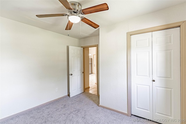609 E Tejon Ave, Bristow, OK 74010 - unfurnished bedroom featuring light carpet, a closet, baseboards, and ceiling fan