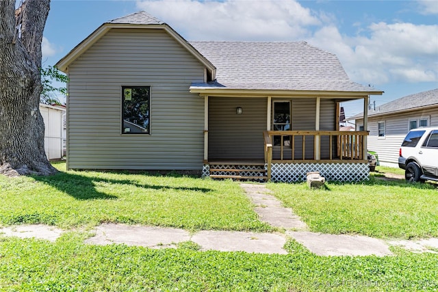 302 E 8th Ave, Bristow, OK 74010 - bungalow-style house featuring a porch, a front lawn, and roof with shingles