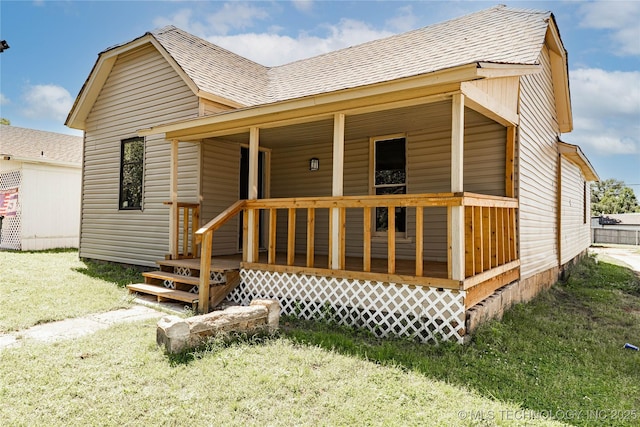 302 E 8th Ave, Bristow, OK 74010 - view of front of house featuring roof with shingles, covered porch, and a front lawn