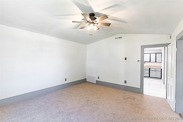 302 E 8th Ave, Bristow, OK 74010 - empty room with a ceiling fan, lofted ceiling, light colored carpet, and baseboards