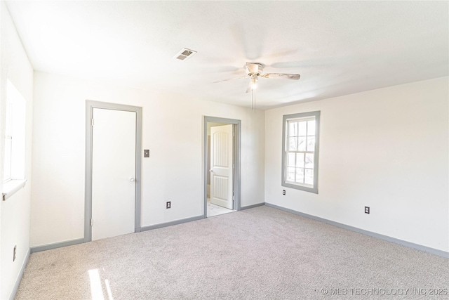 302 E 8th Ave, Bristow, OK 74010 - unfurnished bedroom featuring light colored carpet, baseboards, and ceiling fan