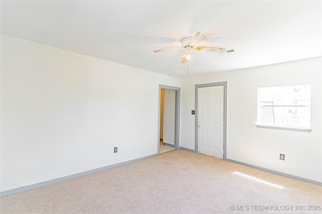 302 E 8th Ave, Bristow, OK 74010 - unfurnished bedroom featuring light carpet, baseboards, and ceiling fan