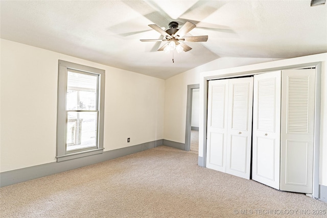302 E 8th Ave, Bristow, OK 74010 - unfurnished bedroom with carpet floors, vaulted ceiling, a closet, and ceiling fan
