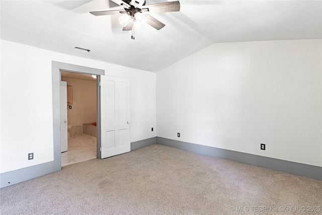 302 E 8th Ave, Bristow, OK 74010 - unfurnished bedroom featuring vaulted ceiling, carpet floors, connected bathroom, a ceiling fan, and baseboards