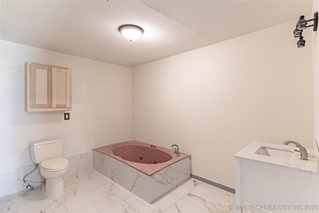 302 E 8th Ave, Bristow, OK 74010 - full bathroom featuring marble look tile flooring, a jetted tub, toilet, vanity, and baseboards