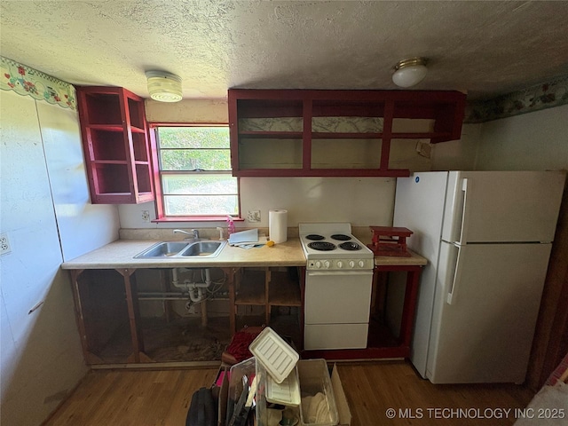 4272 Honey Creek Dr, Davis, OK 73030 - kitchen with white appliances, wood finished floors, a sink, open shelves, and a textured ceiling