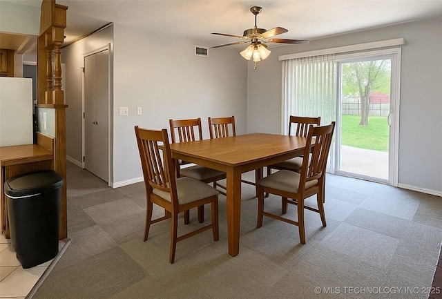 912 Elm, Ardmore, OK 73401 - dining space with light carpet, a ceiling fan, and baseboards