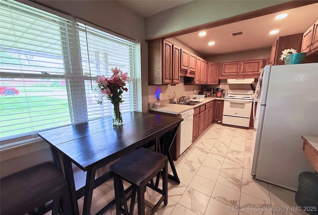 912 Elm, Ardmore, OK 73401 - kitchen featuring white appliances, light marble finish floors, a sink, healthy amount of natural light, and recessed lighting