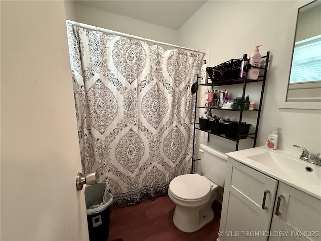 912 Elm, Ardmore, OK 73401 - bathroom featuring vanity, toilet, a shower with curtain, and wood finished floors