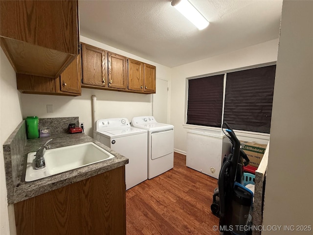 912 Elm, Ardmore, OK 73401 - laundry area featuring washing machine and clothes dryer, cabinet space, and dark wood-style flooring